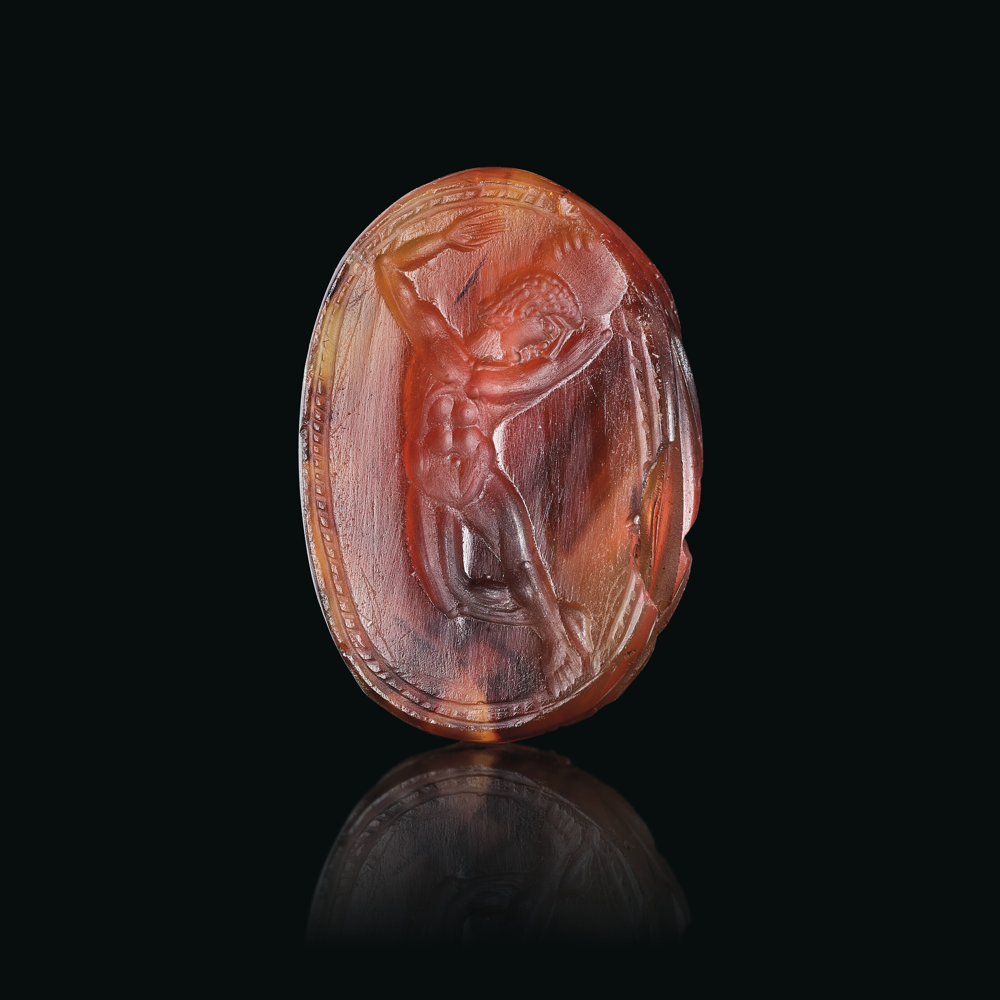 A Greek carnelian scarab with an athlete holding a discus, Archaic period, circa early 5th century B.C., sold for £8,190 on 7 December 2022 at Christie's in London